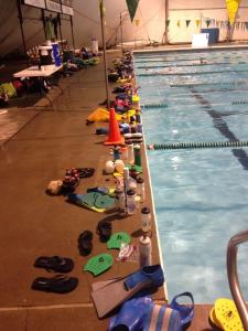 Lots of gear on deck and lots of swimmers in the pool